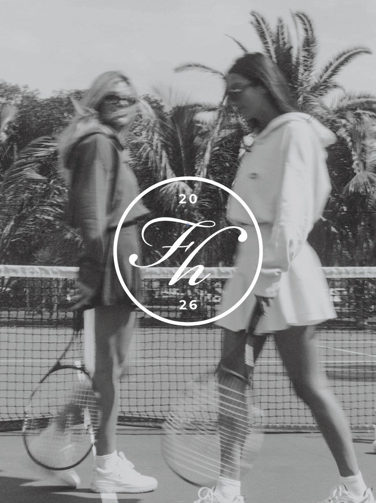 Two women passing each other on a tennis court, with the Fieldhouse seal over the photo